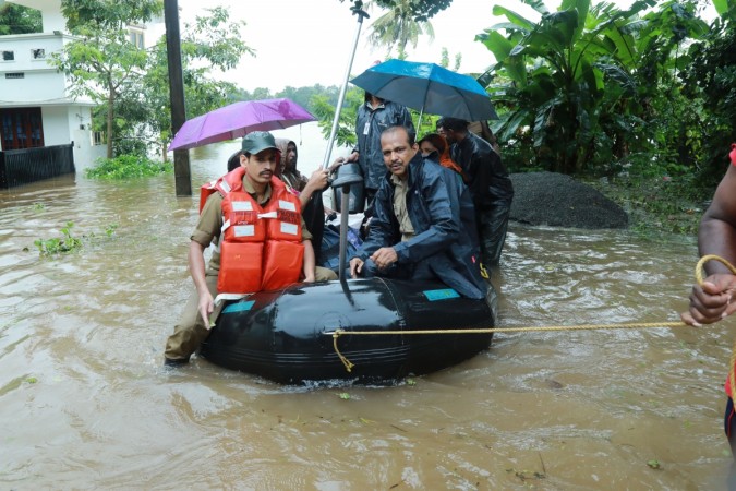 Fire and Rescue personnel evacuate local residents in an inflatable boat from a flooded area at Muppathadam near Eloor in Kochi's Ernakulam district Kerala floods - Muppathadam near Eloor in Kochi's Ernakulam