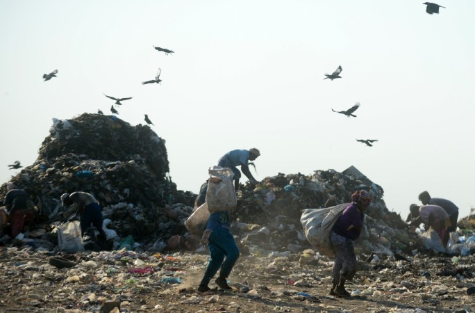Indian ragpickers work in a landfill site on the outskirts of Chennai on May 11, 2018. landfill