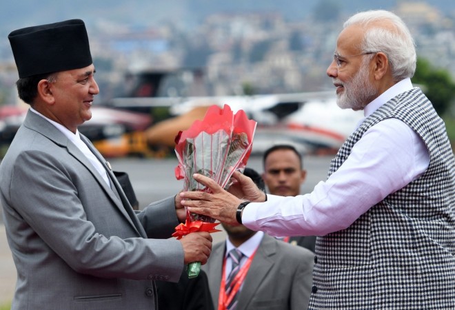Nepal's Deputy Prime Minister and Minister of Defence Ishwor Pokhrel (L) welcomes Indian Prime Minister Narendra Modi (R) on his arrival at Tribhuvan International Airport to attend the 4th Summit of the Bay of Bengal Initiative for Multi-Sectoral Technical and Economic Cooperation (BIMSTEC) in Kathmandu on August 30, 2018 modi
