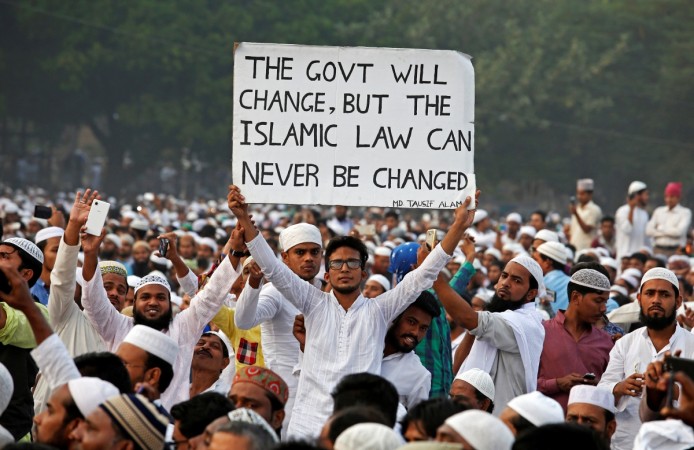 A man holds a banner during a rally organised by All India Muslim Personal Law Board (AIMPLB) to oppose the imposition of a Uniform Civil Code across the country, in Kolkata, India, November 20, 2016. Uniform Civil Code