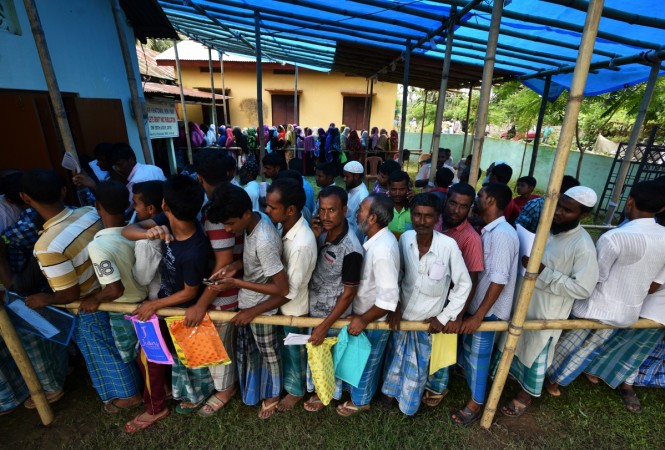 People wait in queue to check their names on the draft list at the National Register of Citizens (NRC) centre at a village in Nagaon district, Assam state, India, July 30, 2018. Assam NRC