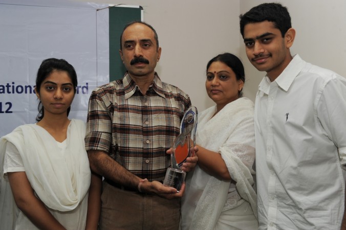 IPS Sanjiv Bhatt (2L) poses with his wife Shweta (2R), daughter Aakashi (L), and son Shantanu (R) after receiving the 5th Mother Teresa Award for Social Justice in Ahmedabad on December 31, 2012. Bhatt was honoured for his accomplishment for standing against communal forces to ensure the protection of vulnerable and insecure minorities. sanjiv bhatt