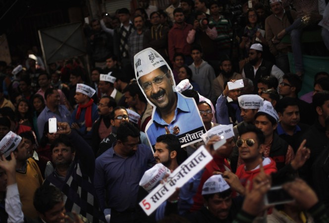 Supporters of AAP hold a portrait of AAP chief and its chief ministerial candidate for Delhi, Kejriwal, delhi cm