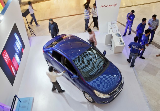 Customers take a look at a car in a Tata showroom. Shopping