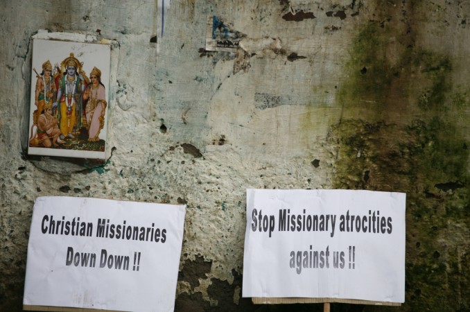 Placards are seen next to a photograph showing Hindu deities during a protest by Indian tribals against Christian missionaries in New Delhi September 6, 2011. The protesters are claiming the missionaries are Conversion to Christianity