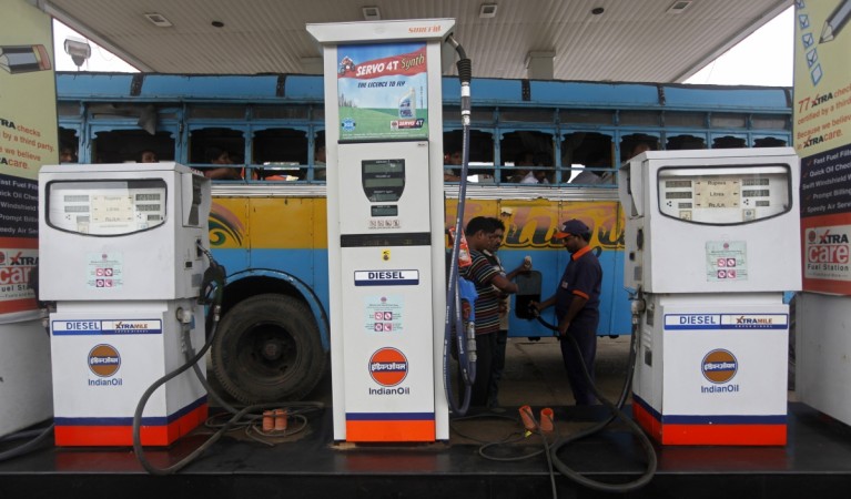 An employee fills diesel in a public bus at a fuel station in Kolkata August 13, 2012. Expect a popular backlash if India's government raises diesel prices to halt the subsidy drain on its finances - not only from the millions of poor who need cheap fuel but from increasing numbers of the well-off and businesses who don't. Picture taken August 13, 2012. india fuel prices