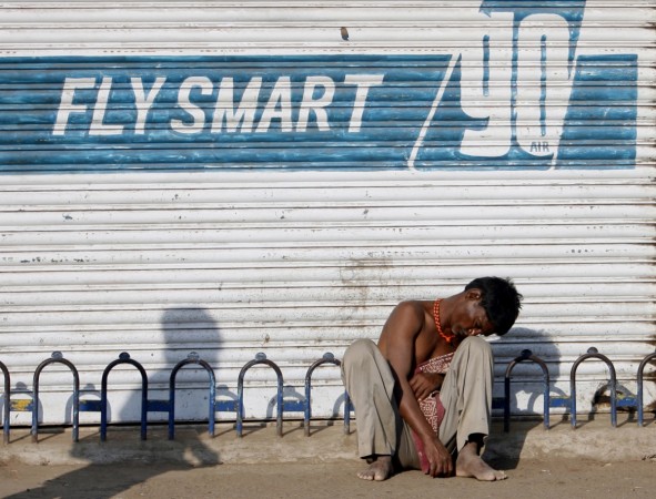 An unemployed migrant worker sits on a pavement in Mumbai