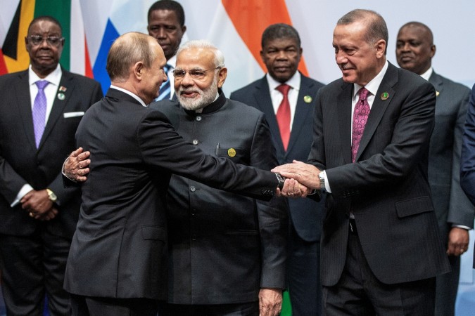 Russian President Vladimir Putin, Indian Prime Minister Narendra Modi and Turkish President Tayyip Erdogan interact before a group picture at the BRICS summit meeting in Johannesburg, South Africa, BRICS