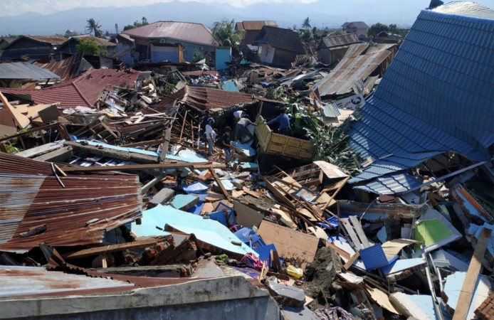 People search through debris in a residential area following an earthquake and tsunami in Palu Indonesia Tsunami