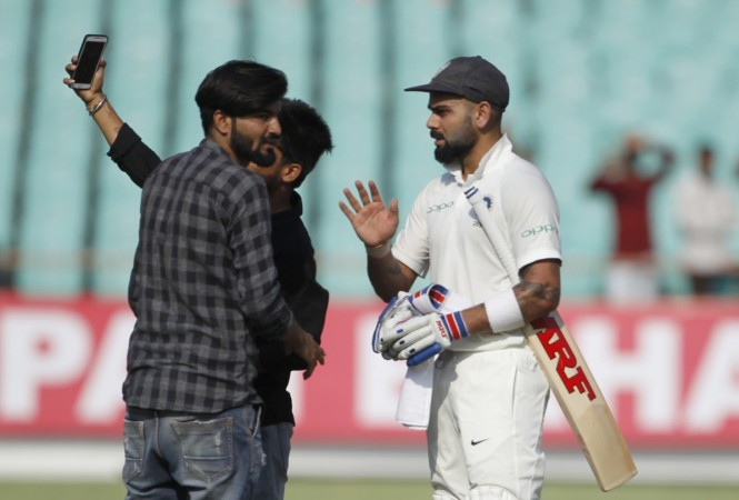 Fans try to click a selfie with Virat Kohli during the 1st Test in Rajkot. Virat Kohli