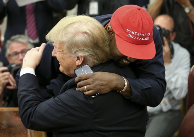 President Trump Hosts Kanye West And Former Football Player Jim Brown At The White House WASHINGTON, DC - OCTOBER 11: (AFP OUT) (EDITORS NOTE: Retransmission with alternate crop.) U.S. President Donald Trump hugs rapper Kanye West during a meeting in the Oval office of the White House on October 11, 2018 in Washington, DC. Donald Trump and Kanye West