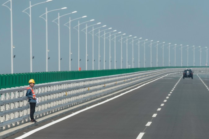 A construction worker stands on a section of the Hong Kong-Zhuhai-Macau Bridge in Zhuhai Hong Kong-Zhuhai bridge