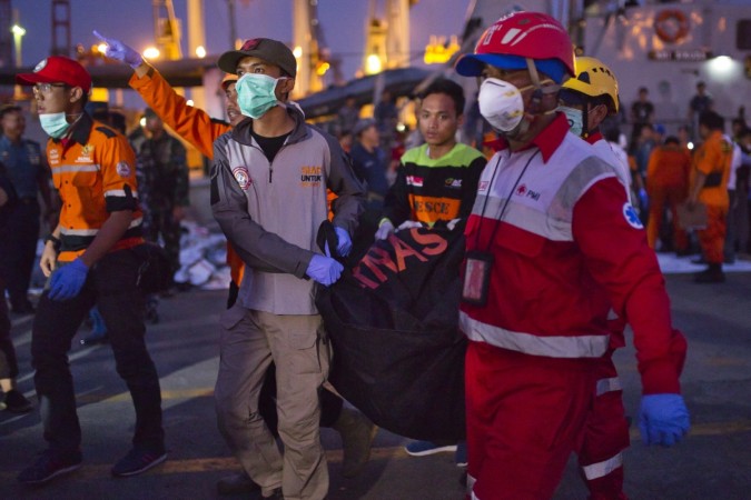 Search and rescue workers move the remains of a victim of the Lion Air flight JT 610 into a waiting ambulance at the Tanjung Priok port on October 29, 2018 in Jakarta, Indonesia. Lion Air