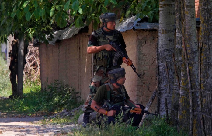 Indian Army soldiers take positions during an encounter with militants in Kashmir. Indian Army soldiers.