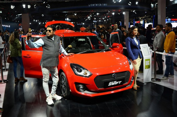 An Indian visitor takes a 'selfie' at a car display during the Indian Auto Expo 2018 Maruti Suzuki Swift, car sales