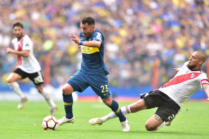 Carlos Tevez of Boca Juniors and Jonatan Maidana of River Plate compete for the bal Carlos Tevez, Boca Juniors