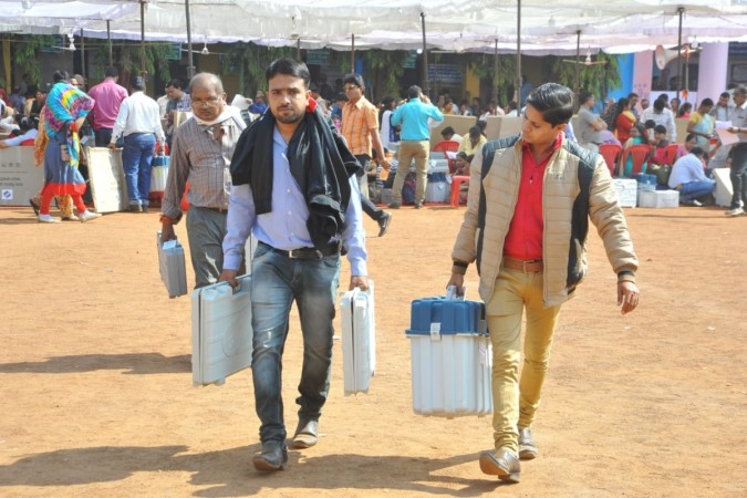 Polling officials carrying the Electronic Voting Machines (EVMs) and other necessary inputs required for the second and final phase of the Chhattisgarh Assembly polls at the distribution centre in Raipur on Nov 19, 2018 chhattisgarh elections