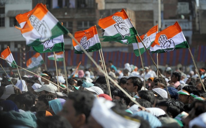 Supporters wave Congress Party flags Supporters wave Congress Party flags