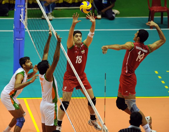 Iran's Vali Nourmohammadi (R) prepares to spike the ball watched against India during their finals match in the third Asian Central Zone Volleyball Championship at Netaji Indoor courts in Kolkata on September 20, 2010 Pro Volleyball League