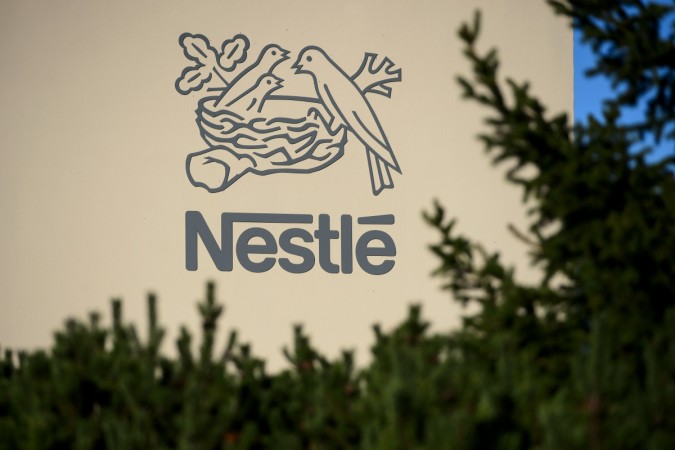 A logo of the world's leading food industry group Nestle is seen on October 9, 2014 at the group's Research Center in Vers-chez-les-Blanc above Lausanne. NESTLE