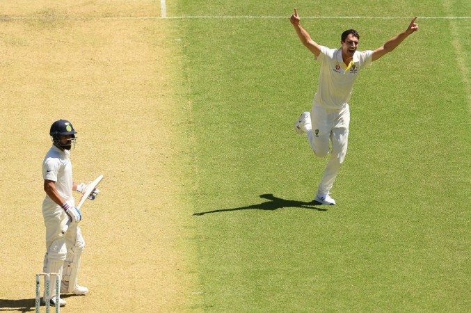 Cummins (R) celebrates after dismissing Kohli (L) on day 1 at Adelaide Virat Kohli
