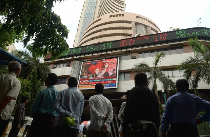 Pedestrians watch as a digital broadcast presents the rolling share price information on the facade of the Bombay Stock Exchange (BSE) building in Mumbai. Market choppiness is likely to increase as voting in the seven-phase general election progresses, experts say. Bombay Stock Exchange (BSE)