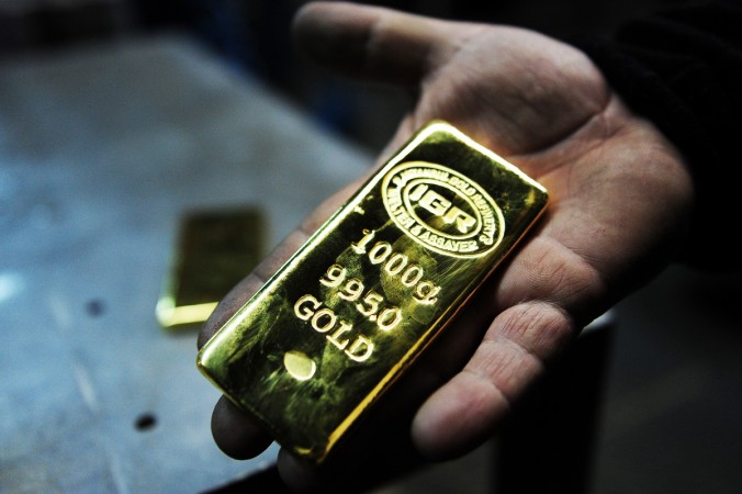 TO GO WITH AFP STORY BY PHILIPPE ALFROY A gold worker holds a 1 KG gold bullion at Istanbul Gold Refinery (IGR) on January 13, 2015 in Istanbul. Since 2007, Turkish banks have opened gold accounts in their branches to collect gold bullions, coins, jewels as well as scrap gold that Turkish people are keeping 'under the pillow' and to reintroduce it in the financial system so it can benefit the whole economy. It is estimated that Turkish households have accumulated at least 3,500 tons of gold 'under the pillow'.AFP PHOTO/OZAN KOSE Gold bar