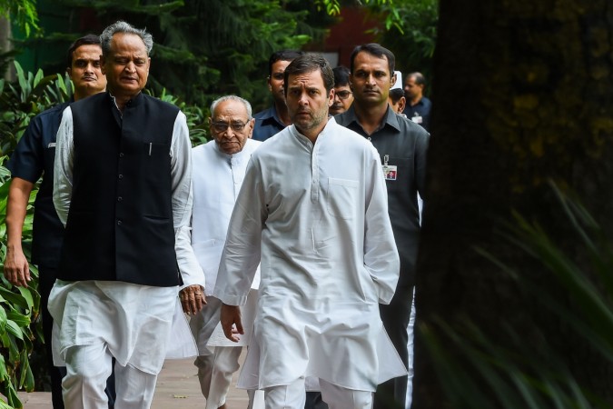 President of the Indian National Congress Party Rahul Gandhi (R) talks with Congress party's national general secretary Ashok Gehlot (L) and party memeber Motilal Vora (C) at the All India Congress Committee offices where Gandhi met the Congress Working Committee in New Delhi on August 4, 2018. (Photo by CHANDAN KHANNA / AFP) President of the Indian National Congress Party Rahul Gandhi (R) talks with Congress party's national general secretary Ashok Gehlot (L)