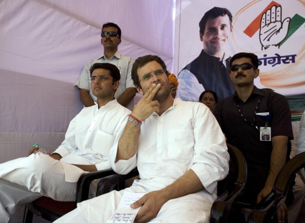 Congress Party General Secretary Rahul G Congress Party General Secretary Rahul Gandhi (C) and Congress Party candidate Sachin Pilot (L) listen to an unseen speaker at a rally in Ajmer on May 4, 2009, during campaigning ahead of the fourth of five phases in the national elections. India holds its 15th parliamentary general elections in five phases on April 16, April 23, April 30, May 7 and May 13 and the new parliament will be constituted before June 2, 2009. AFP PHOTO/Findlay KEMBER Rahul Gandhi and Sachin Pilot