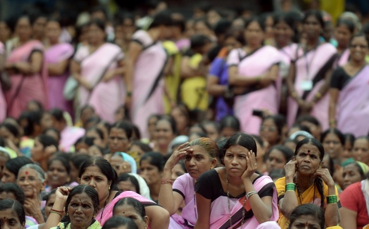 Members of the Indian Anganwadi Workers look on during a protest rally in Mumbai on September 24, 2013. The demonstrators were demanding better working conditions and a raise in salary, pension and gratuity in accordance with government rules. AFP PHOTO/ PUNIT PARANJPE INDIA-POLITICS-ANGANWADI-PROTEST