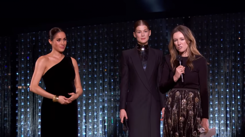 Meghan Markle seen cradling her baby bump at the British Fashion awards Meghan Markle