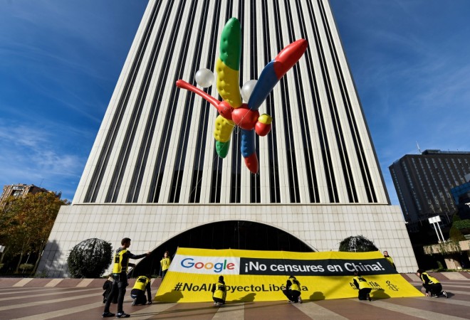 Amnesty International activists hold a giant dragonfly-shaped balloon with a banner reading 'Google, do not censor in China, no to the Dragonfly project' during a protest outside the Google headquarters in Madrid on November 27, 2018 as part of a campaign calling on Google to cancel its controversial plan to launch a censored search engine in China. (Photo by OSCAR DEL POZO / AFP) SPAIN-CHINA-GOOGLE-INTERNET-RIGHTS-AMNESTY