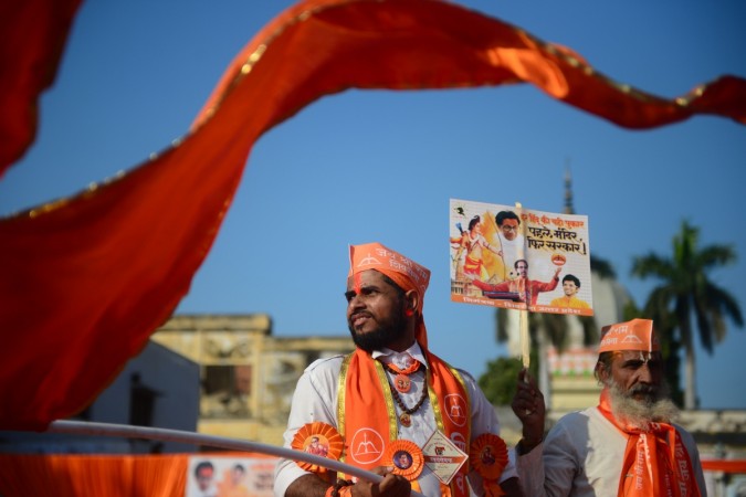Shiv Sena activists wave a flag at Lakshman Qila during an event for the construction of Ram temple in Ayodhya. INDIA-RELIGION-POLITICS