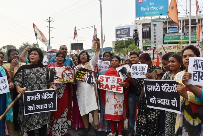 Indian National Congress party activist hold placards and shout slogans during a protest against the recent abduction and gang-rape of five charity workers in Chochang village of Khunti district, in Ranchi on June 23, 2018. INDIA-CRIME-WOMEN-RAPE