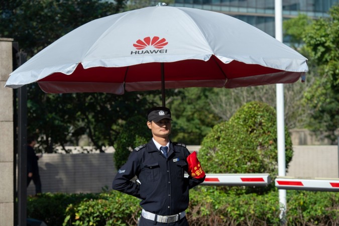 A security guard keeps a watch at the entrance to the Huawei global headquarters in Shenzhen in China. The announcement of Huawei's 5G deal with Russia is significant in that it comes ahead of President Xi Jinping's summit with President Vladimir Putin. Huawei