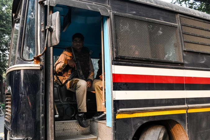 Delhi police security personnel guard a bus carrying suspected members of a militant group 'Harkat ul Harb-e-Islam' outside the Patiala Court in New Delhi on December 27, 2018. - India's anti-terror agency on December 26 said it had busted a local militant cell inspired by the Islamic State group that was planning to carryout bombings and target prominent political figures. (Photo by CHANDAN KHANNA / AFP) militant group 'Harkat ul Harb-e-Islam' outside the Patiala Court in New Delhi on December 27, 2018