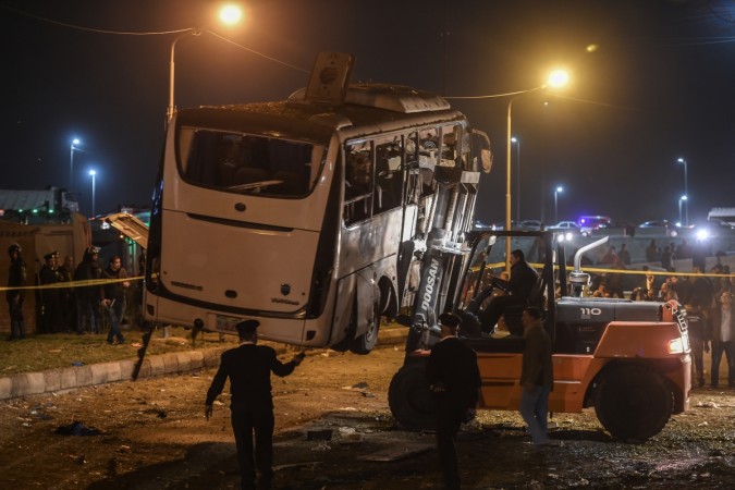 This picture taken on December 28, 2018 shows a tourist bus which was attacked being towed away from the scene, in Giza province south of the Egyptian capital Cairo. - Three Vietnamese holidaymakers and an Egyptian tour guide were killed December 28, 2018, when a roadside bomb blast hit their bus as it travelled close to the Giza pyramids outside Cairo, officials said. giza bus blast