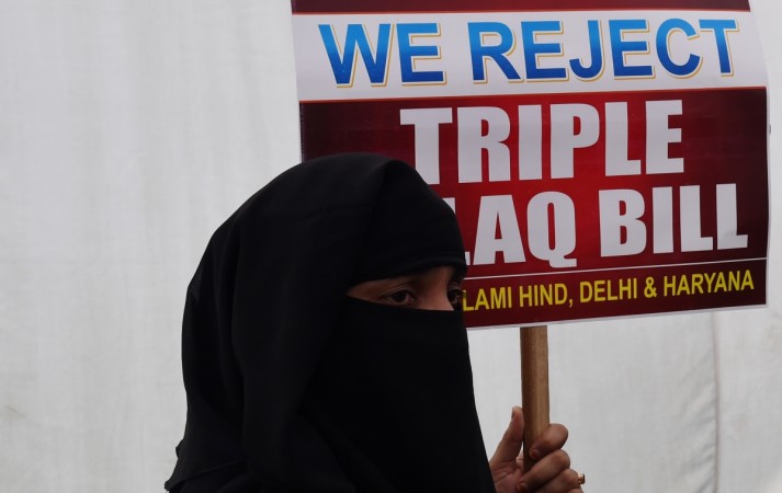 An Indian Muslim woman holds a placard during a protest against the 'triple talaq bill' in New Delhi on April 4, 2018. Muslim women in India have gathered to protest the 'Muslim Women (Protection of Rights on Marriage) Bill 2017' that makes triple talaq illegal. Instant divorce or 'triple talaq' is when a Muslim man ends his marriage by simply saying 'talaq' (which means 'you are divorced' in Arabic) three times in succession. triple talaq