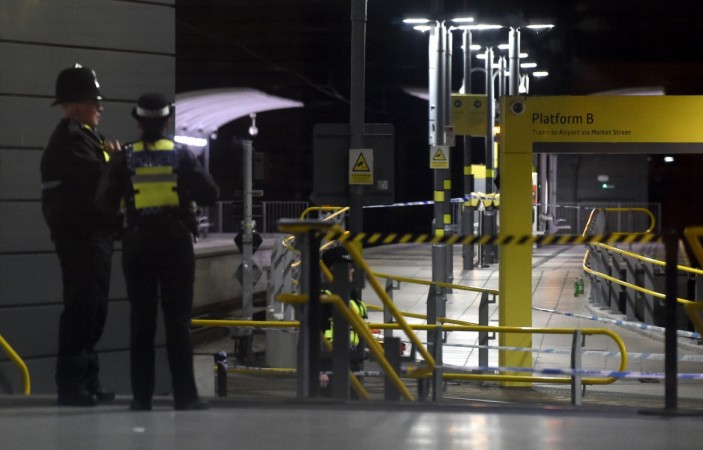 Police officers stand near a cordon at Manchester Victoria Station, in Manchester on January 1, 2019, following a stabbing on December 31, 2018. - A man, a woman and a police officer were being treated for knife injuries, police said Monday, after a stabbing at a railway station in the British city of Manchester. london police