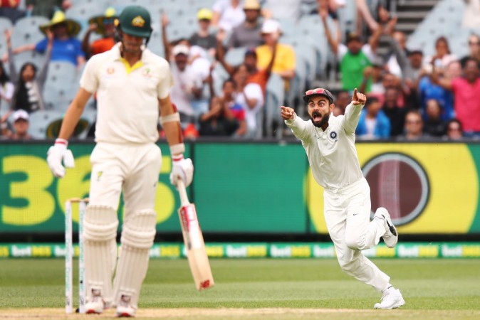 Kohli celebrating the fall of Cummins' wicket at Melbourne on day 5. Virat Kohli Pat Cummins