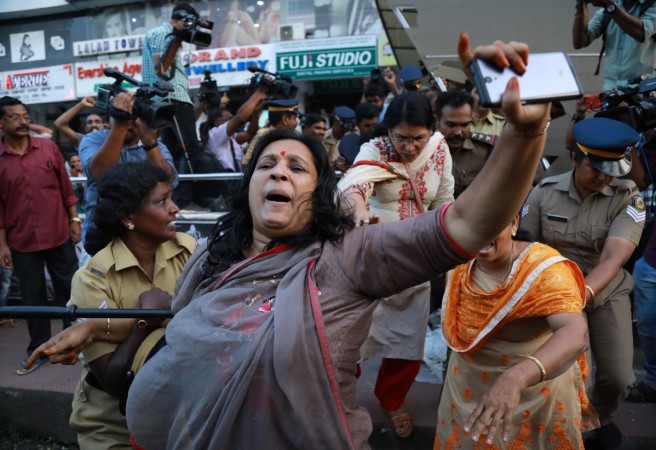 India police intervene as members of Sabarimala Karma Samithi try to disrupt a celebratory meeting after two women entered Sabarimala Ayyapa temple, at the High Court Junction in Kochi in the Indian state of Kerala on January 2, 2019. - Two women in their 40s defied traditionalists on January 2 to enter the Sabarimala temple, one of Hinduism's holiest sites, sparking violent clashes in southern India. (Photo by - / AFP) India police intervene as members of Sabarimala Karma Samithi try to disrupt a celebratory meeting after two women entered Sabarimala Ayyapa temple