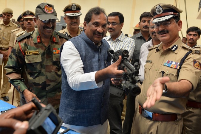 Karnataka Home Minister KJ George (C), along with police and military officers, checks some of the latest weaponry acquired by the 'Garuda Commandos' of the Internal Security Division (ISD) during the minister's visit to the Centre for Counter Terrorism (CCT) in Bangalore on June 3, 2014. KJ George