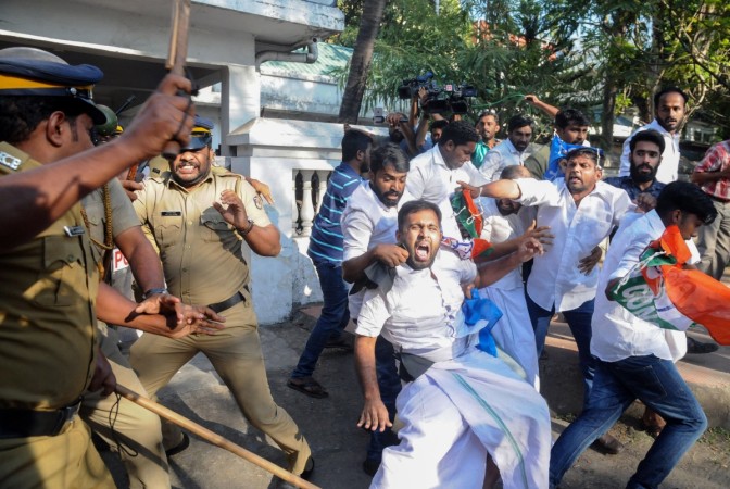 Clashes broke out in southern India for a second day on January 3 as Hindu hardliners went on the rampage, seeking to enforce a general shutdown in protest at two women entering one of the country's holiest temples. Indian police beat Congress Party supporters as they take them into custody during a protest march