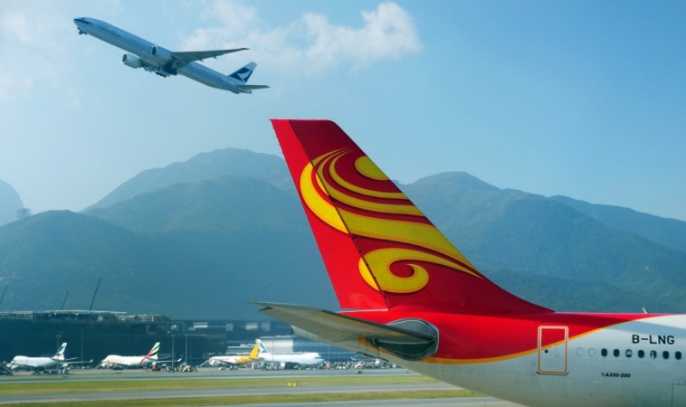 This photo taken on October 31, 2011 shows a Cathay Pacific plane (top L) taking off past a Hong Kong Airlines Airbus A330-200 passenger jet (R) on the tarmac at Hong Kong's international airport. Airbus and Hong Kong Airlines have struck a deal worth about 3.8 billion USD at list prices to buy 10 superjumbo A380 jets, reports said on January 7, 2012. AFP PHOTO / RICHARD A. BROOKS Hong Kong Airlines Airbus A330-200 passenger jet