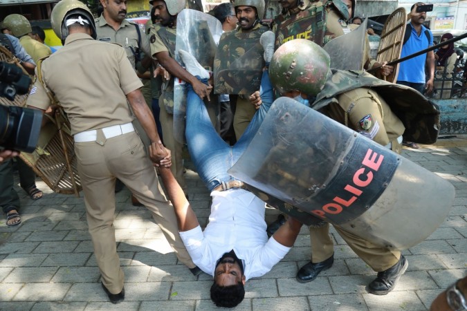 Police detain an Indian activist amid demonstrations after women entered the Sabarimala temple, in Kochi in southern Kerala state, on January 4, 2019. - Police in southern India said January 4 that a third woman has entered a flashpoint temple, stoking tensions after two days of clashes involving Hindu hardliners and police. Police said that 1,369 people have been arrested in clashes in retaliation over the women's entry. Police detain an Indian activist amid demonstrations after women entered the Sabarimala temple