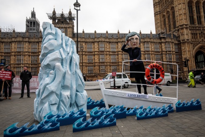 LONDON, ENGLAND - JANUARY 15: A demonstration featuring a paper mâché Theresa May head sailing towards an iceberg is staged by campaign group Avaaz outside the Houses of Parliament on January 15, 2019 in London, England. Theresa May's Brexit deal finally reaches the House of Commons this evening and MPs will begin voting on it at 7pm. The Prime Minister has consistently said her's is the only deal that Brussels will entertain and urged support from Parliament to avoid the UK crashing out of the European Union with no deal. MPs Vote On Theresa May's Brexit Deal