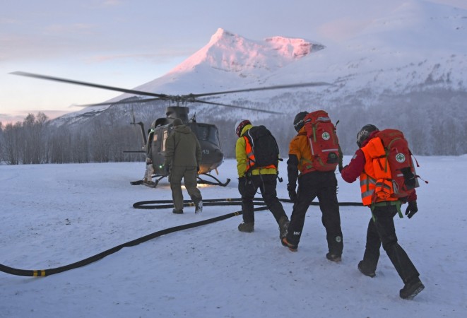Police and volunteers of the Red Cross take part in the operations to recover the bodies of the tourists who were buried in snow during an avalanche in the Blåbærfjellet mountain, on January 17, 2019, near Nordkjosbotn in Tamokdalen valley, northern Norway. NORWAY-AVALANCHE