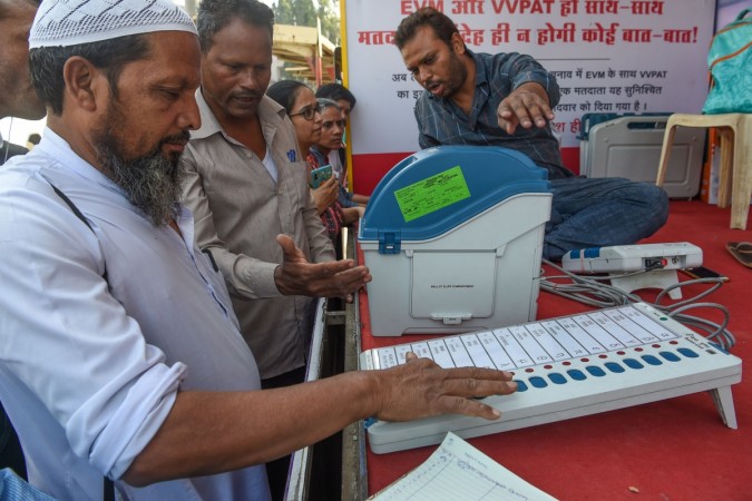 People try out the Electronic Voting Machine (EVM) in conjunction with the Voter-Verified Paper Audit Trail (VVPAT), a ballotless voting system, at an Election Commission demonstration stand in Mumbai on January 16, 2019. The election commission's campaign for transparency in campaign funding got a boost with the Supreme Court order asking political parties to deposit details of donations received through electoral bonds with the Election Commission by May 30. Electronic Voting Machine