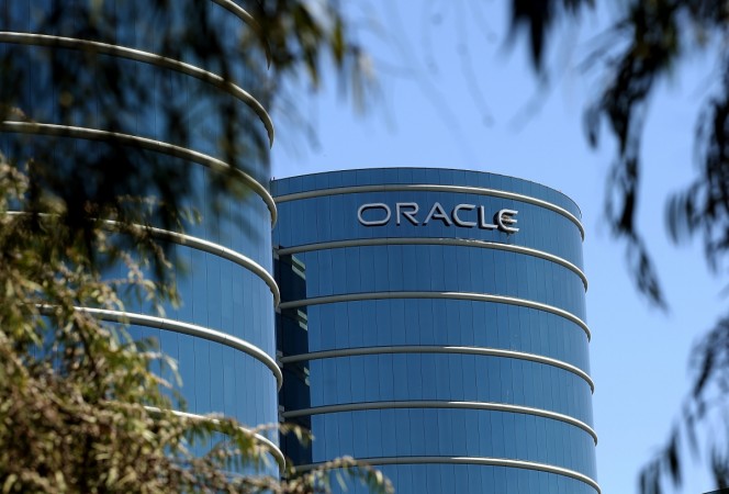 The Oracle logo is displayed on the exterior of the Oracle headquarters in Redwood Shores, California. Oracle