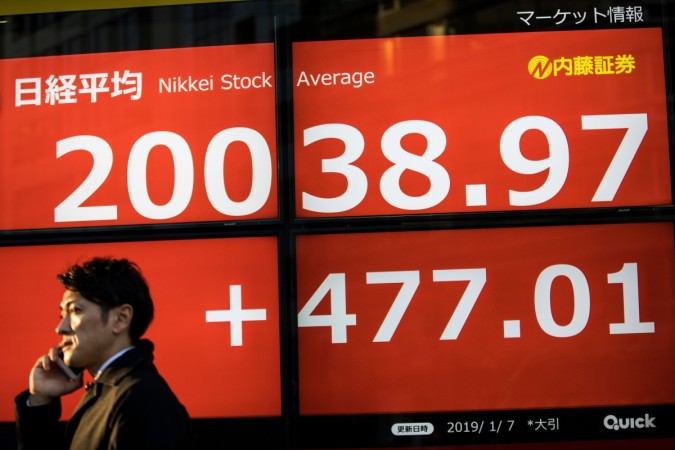 (REPRESENTATIONAL IMAGE) A pedestrian walks past a stock indicator board displaying share prices of the Tokyo Stock Exchange in Tokyo on January 7, 2019. asian stock market